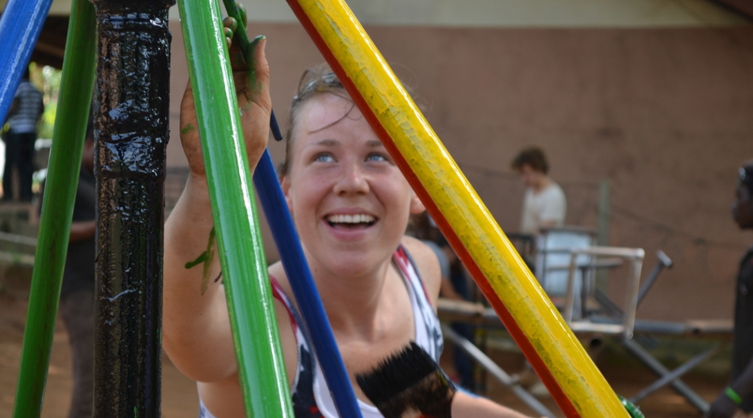 A Projects Abroad volunteer building in Ghana, helps paint a playground A volunteer paints a playground as part of her construction volunteering in Ghana